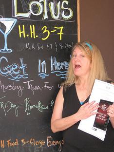 photo of Denise in front of menu board