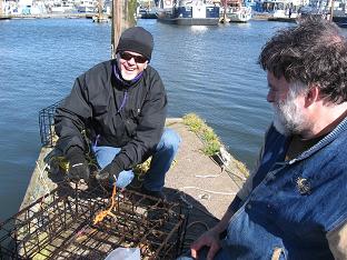 photo of Bruce & Kevin putting crab pot in