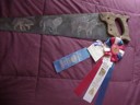 photo of painted hand saw with Rosette